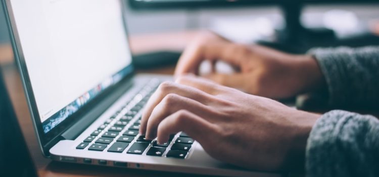 Person typing on computer